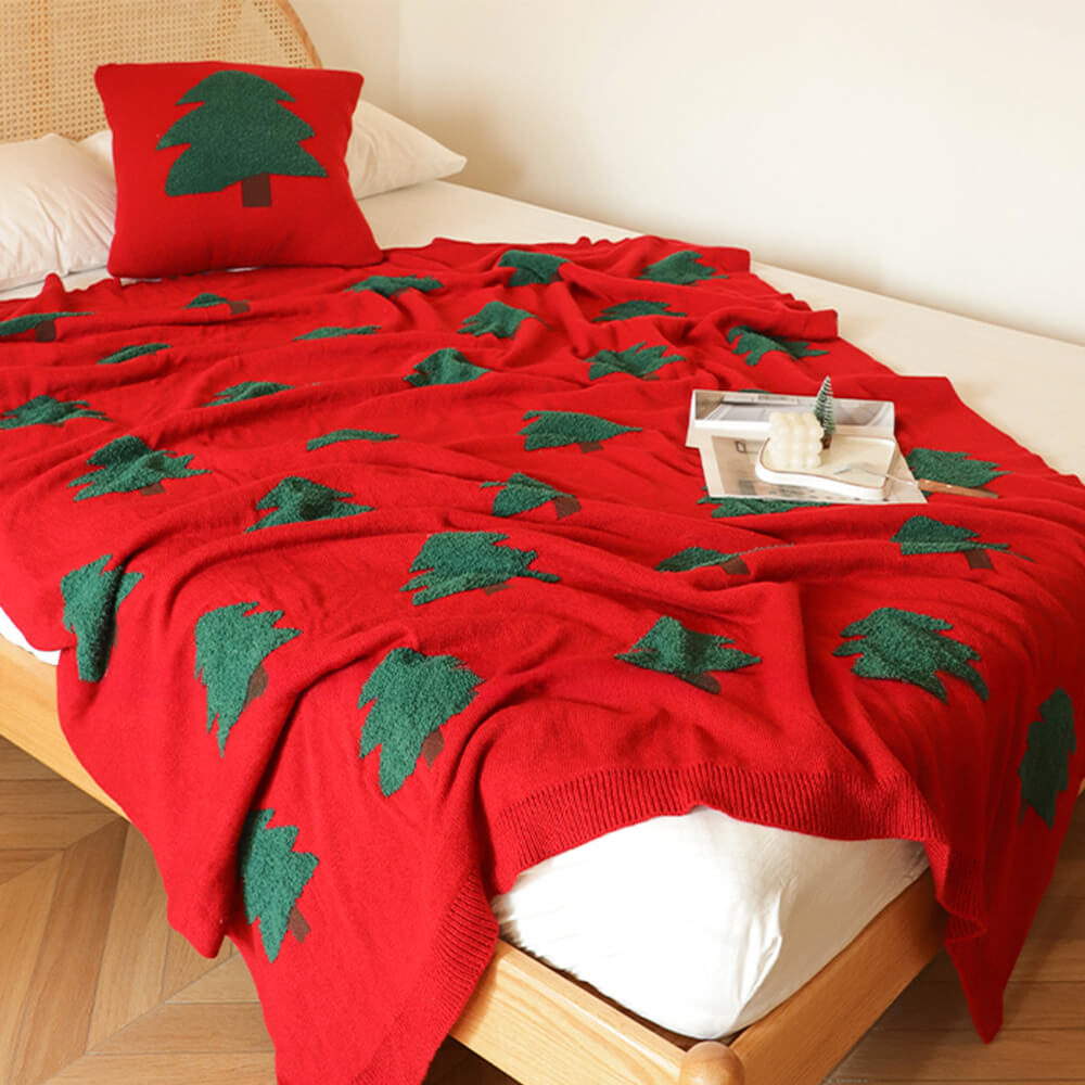 Festliche gestrickte Decke mit Weihnachtsbaummuster und Kissen